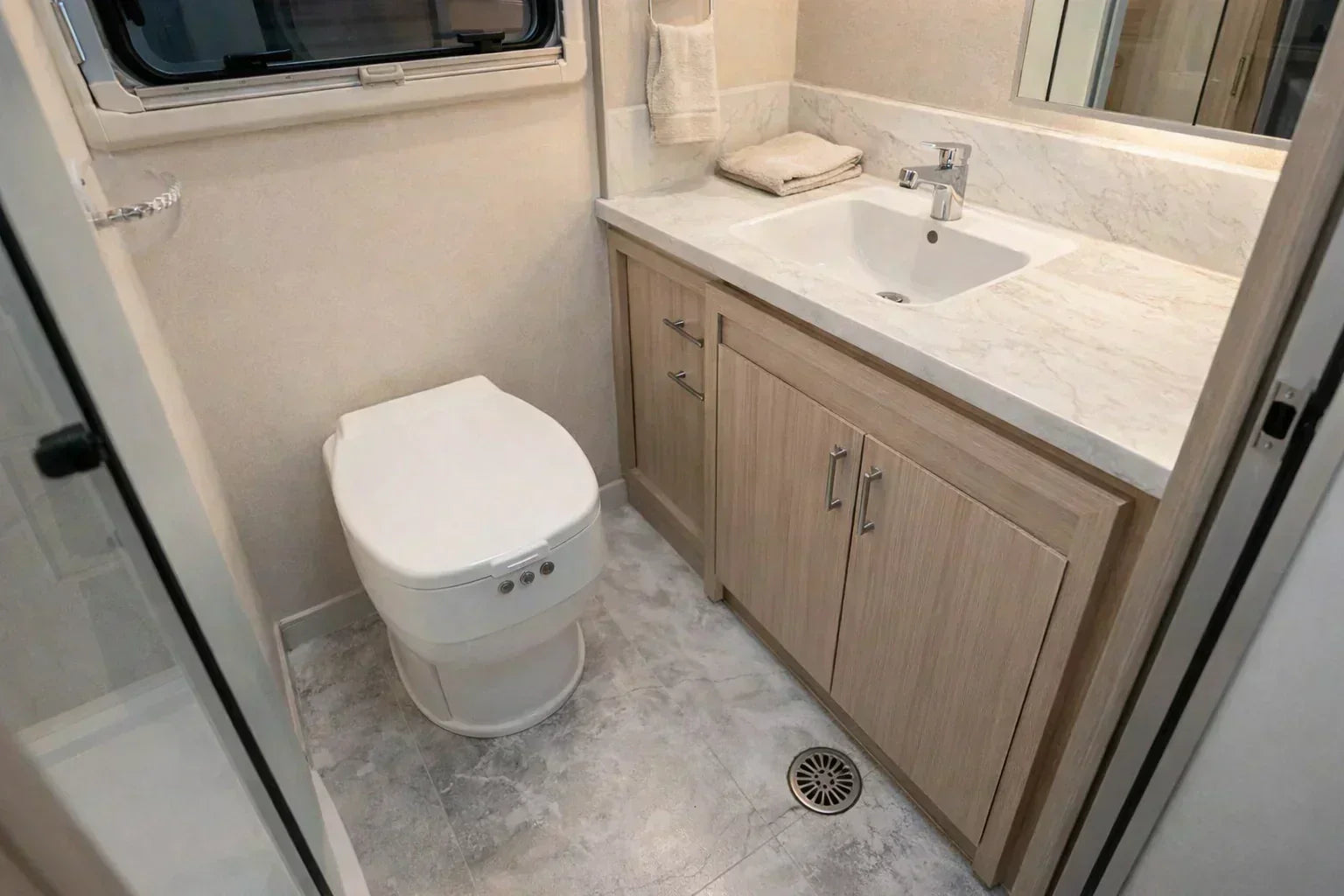 Camper replacement toilet installed in a compact RV bathroom, showing a waterless dry flush toilet setup without plumbing or black tank